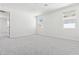 Bright bedroom with neutral carpet, two windows and ample space, creating a relaxing and inviting atmosphere at 1123 E Mcneil St, Phoenix, AZ 85042