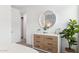 Bright bedroom featuring a modern dresser, stylish mirror, and a view into the ensuite bathroom at 1123 E Mcneil St, Phoenix, AZ 85042