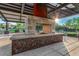 Outdoor gathering space with modern fire pit, shaded seating, and desert landscaping at 1123 E Mcneil St, Phoenix, AZ 85042