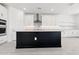 Modern kitchen features white cabinets, stainless steel appliances, a subway tile backsplash and a large island at 1123 E Mcneil St, Phoenix, AZ 85042