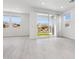 Bright living space features hard surface floors, neutral walls, large windows, and sliding patio door at 1123 E Mcneil St, Phoenix, AZ 85042