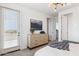 Bright main bedroom with a private balcony, light wood dresser, and modern decor at 1123 E Mcneil St, Phoenix, AZ 85042