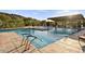 Spacious community pool area with shade structure and multiple lounge chairs at 1123 E Mcneil St, Phoenix, AZ 85042