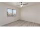 Bright bedroom with light grey wood-look flooring and large window at 11612 W Alvarado Rd, Avondale, AZ 85392