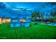 Backyard with a built-in grill, artificial turf, and seating area, perfect for outdoor entertaining and relaxation at 12209 N 66Th St, Scottsdale, AZ 85254
