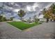 Spacious backyard features lush green lawn, seating area, BBQ, perfect for outdoor gatherings at 12209 N 66Th St, Scottsdale, AZ 85254
