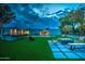 Beautiful backyard with a pool, outdoor kitchen, and lush artificial turf, perfect for relaxation and entertaining at 12209 N 66Th St, Scottsdale, AZ 85254