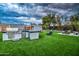 Lush backyard featuring an outdoor kitchen, a fire pit, built-in grill, and ample seating for entertaining at 12209 N 66Th St, Scottsdale, AZ 85254