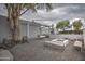 Backyard featuring a fire pit, a swing and mature trees at 12209 N 66Th St, Scottsdale, AZ 85254