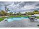 Lush backyard features a sparkling pool, well-manicured lawn, and stylish outdoor seating areas at 12209 N 66Th St, Scottsdale, AZ 85254