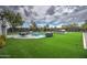 Expansive backyard features a refreshing pool, outdoor dining area, a grill and bar with artificial grass at 12209 N 66Th St, Scottsdale, AZ 85254