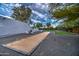 Backyard features gravel, a bocce ball court, comfortable seating, and manicured landscaping at 12209 N 66Th St, Scottsdale, AZ 85254