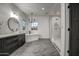 Bright bathroom featuring a soaking tub, walk-in shower, double vanity, and natural light at 12209 N 66Th St, Scottsdale, AZ 85254