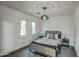 Beautiful bedroom featuring modern lighting, two windows, and stone floors at 12209 N 66Th St, Scottsdale, AZ 85254