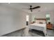 Bright bedroom features a ceiling fan, ensuite bathroom, and charming windows with a view at 12209 N 66Th St, Scottsdale, AZ 85254