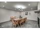 Dining room with sleek chandelier and tile accented fireplace in the background at 12209 N 66Th St, Scottsdale, AZ 85254