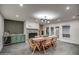 Bright dining room features a long wood table, stylish seating, and an eye-catching fireplace with a built-in bar area at 12209 N 66Th St, Scottsdale, AZ 85254