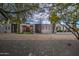 Home exterior with modern design, beautiful trees, and a desert landscape at 12209 N 66Th St, Scottsdale, AZ 85254