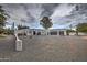 Exterior shot of a large, modern house with a gravel driveway at 12209 N 66Th St, Scottsdale, AZ 85254