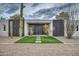 Contemporary home featuring a desert landscape, black metal accents, and a gray gravel yard at 12209 N 66Th St, Scottsdale, AZ 85254