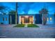 Modern home exterior featuring a decorative front entrance, artificial turf, desert landscaping, and gravel driveway at 12209 N 66Th St, Scottsdale, AZ 85254