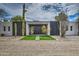 Stunning modern home with desert landscaping, black doors, and artificial grass at 12209 N 66Th St, Scottsdale, AZ 85254