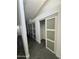 Hallway with modern sliding glass door closets, offering ample storage space and contemporary style at 12209 N 66Th St, Scottsdale, AZ 85254