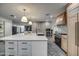 Open kitchen featuring a central island, stainless steel appliances, and views into the living area at 12209 N 66Th St, Scottsdale, AZ 85254