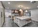 Modern kitchen with a large island, white marble countertops, and custom cabinetry at 12209 N 66Th St, Scottsdale, AZ 85254