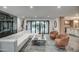 Open-concept living room featuring a sectional, stylish chairs, and sliding glass doors with tile flooring at 12209 N 66Th St, Scottsdale, AZ 85254