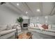 Bright living room featuring high ceilings with beams and a fireplace with decorative tile surround at 12209 N 66Th St, Scottsdale, AZ 85254