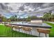 Backyard kitchen features a large island with bar seating, a built-in grill, sink, and manicured artificial grass at 12209 N 66Th St, Scottsdale, AZ 85254