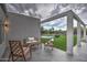 Outdoor patio featuring a stone floor and a view of the outdoor bar and pool at 12209 N 66Th St, Scottsdale, AZ 85254