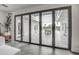 Large sliding glass doors open to an inviting outdoor patio with seating at 12209 N 66Th St, Scottsdale, AZ 85254