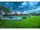 Lush backyard featuring a pool, elegant patio, and manicured landscaping at 12209 N 66Th St, Scottsdale, AZ 85254
