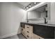 Stylish double vanity with modern sinks, black fixtures, and custom wood cabinetry at 12209 N 66Th St, Scottsdale, AZ 85254