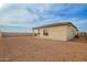 Exterior view showcasing a large unfinished backyard with a block wall and the back of the home at 13653 W Crabapple Dr, Peoria, AZ 85383