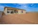 Home exterior with a large, unfinished backyard and a concrete patio, ready for landscaping and outdoor activities at 13653 W Crabapple Dr, Peoria, AZ 85383