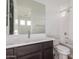 Bright bathroom features a modern vanity with sleek countertops and fixtures, plus a bathtub-shower combo at 13653 W Crabapple Dr, Peoria, AZ 85383
