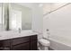 Bright bathroom features a combination shower and tub, dark cabinets and bright white sink at 13653 W Crabapple Dr, Peoria, AZ 85383