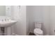 Bright half-bath with pedestal sink, toilet, and modern fixtures at 13653 W Crabapple Dr, Peoria, AZ 85383