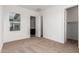 Bright bedroom features a neutral carpet, white trim, and view of a walk in closet at 13653 W Crabapple Dr, Peoria, AZ 85383