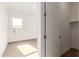 Bright bedroom features a neutral carpet, white trim, and view of a closet at 13653 W Crabapple Dr, Peoria, AZ 85383