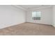 Neutral bedroom with carpet, a tray ceiling, and a window for natural light at 13653 W Crabapple Dr, Peoria, AZ 85383