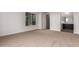 Bright bedroom features a neutral carpet, white trim, and view of a bathroom at 13653 W Crabapple Dr, Peoria, AZ 85383