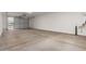 Spacious garage with a roll-up door, concrete flooring, and utility connections, ready for parking and storage at 13653 W Crabapple Dr, Peoria, AZ 85383