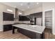 Modern kitchen features a large island, stainless steel appliances, and ample cabinet space at 13653 W Crabapple Dr, Peoria, AZ 85383