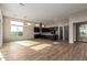 Open-concept living and kitchen area with hardwood floors and modern lighting at 13653 W Crabapple Dr, Peoria, AZ 85383