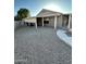 Covered patio and low-maintenance gravel backyard, perfect for relaxation and outdoor gatherings at 15659 W Ripple Cir, Goodyear, AZ 85338