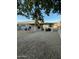 Spacious backyard with low-maintenance gravel landscaping and a covered patio, perfect for outdoor living at 15659 W Ripple Cir, Goodyear, AZ 85338